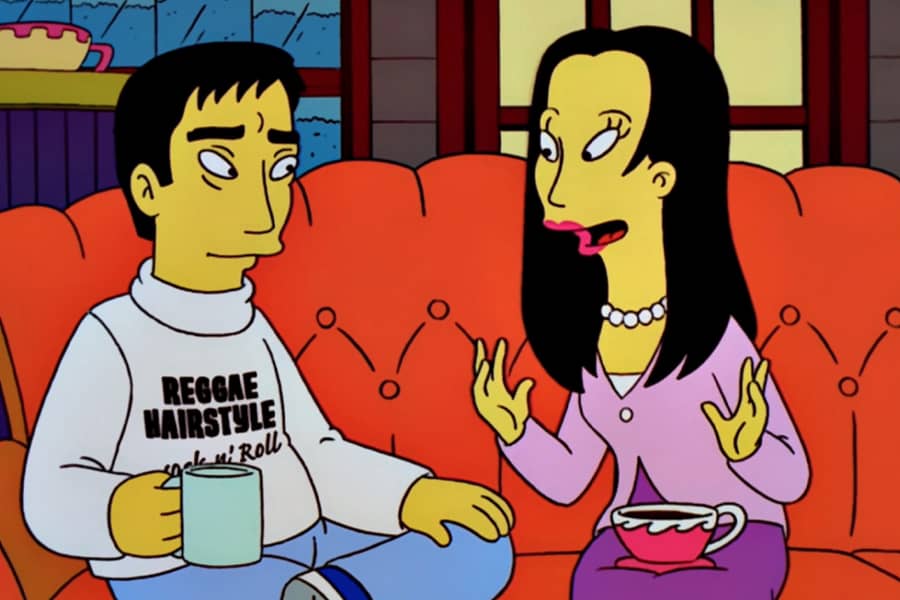 one of the women talking with a coffee cup on her lap