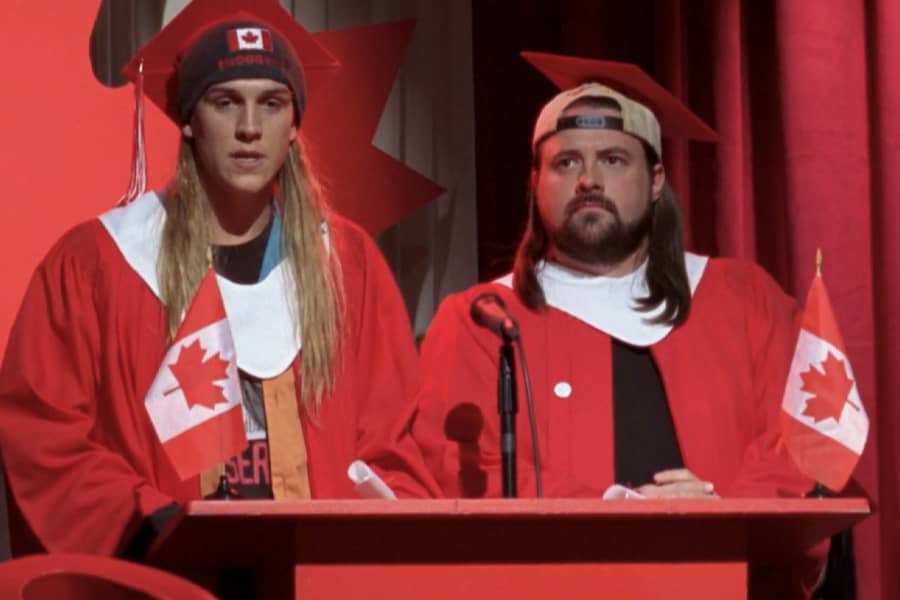 Jay and Silent Bob speaking at graduation and everything is covered in Canadian flags