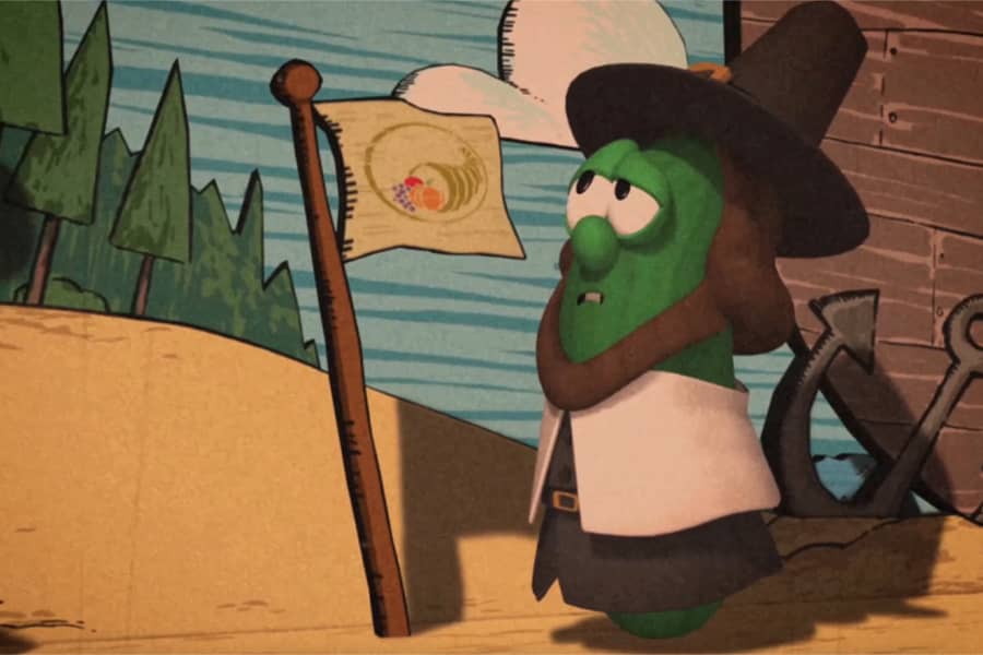Obadiah Bumbly, a pilgrim cucumber, planting a flag on the beach