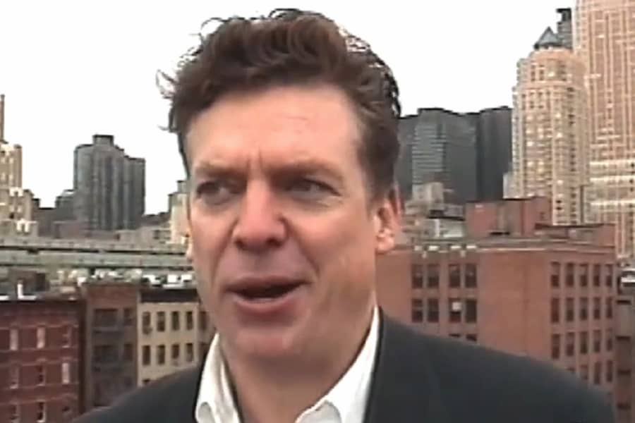 Tibbons talking on a city rooftop