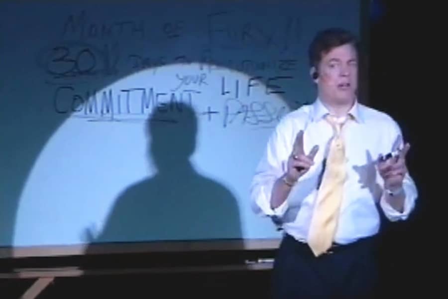 Tibbons giving a talk in front of a white board