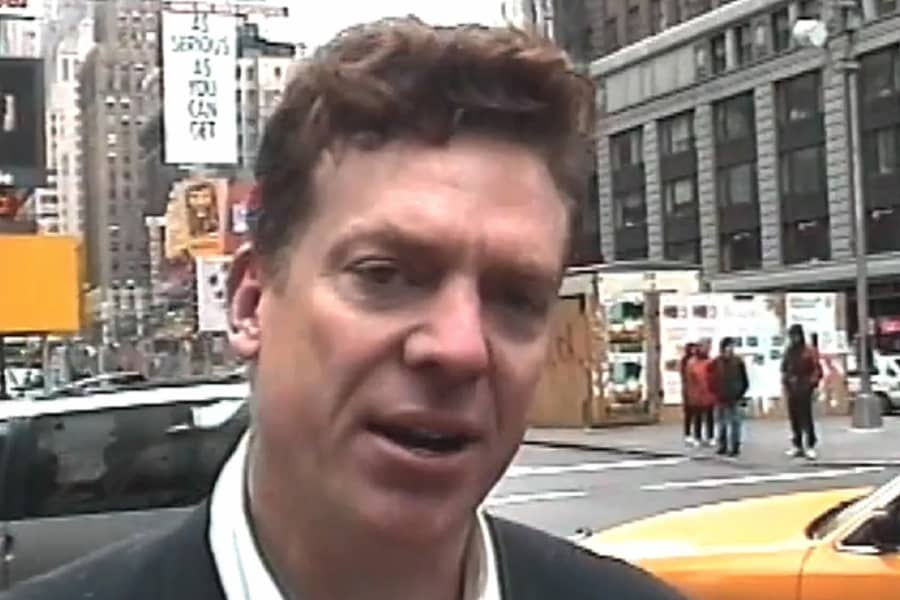 Tibbons talking on a city street