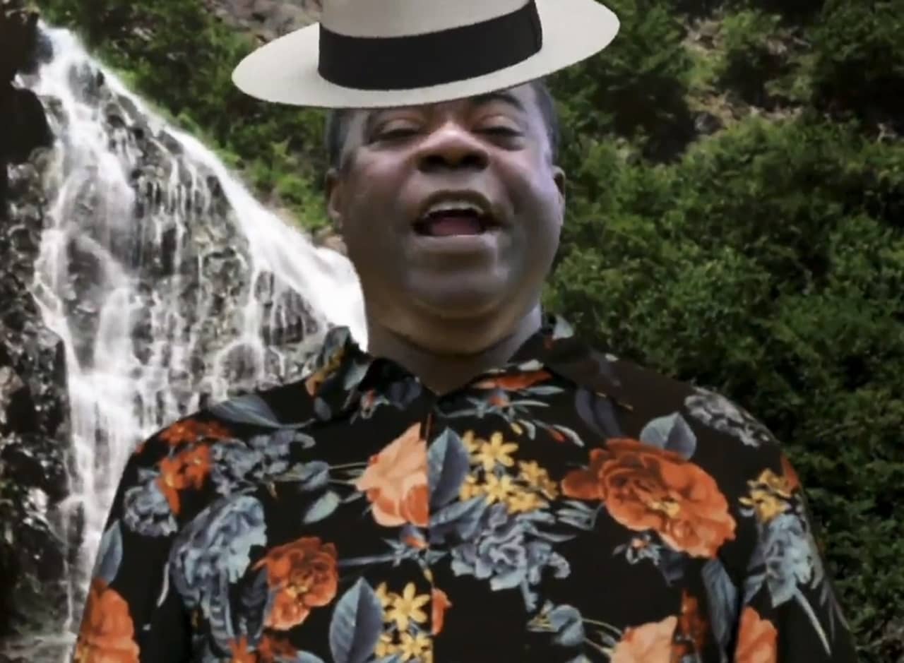 Tracy Jordan with a Hawaiian shirt, and hat composited on him in front of a jungle green screen