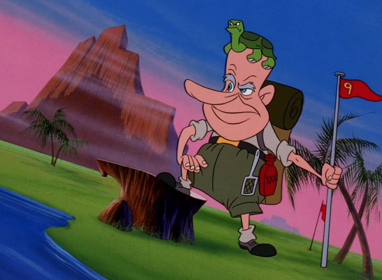 Martin Pardon in nature, holding a flag, carrying a camp pack, and with a small turtle on his head