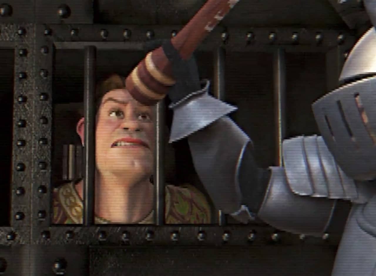 Shrek in human form peering out of a cell, a knight grinding pepper into his eyes