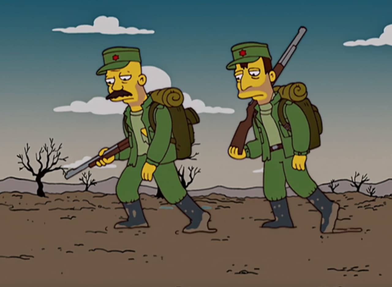 two soldiers plodding along a wasteland