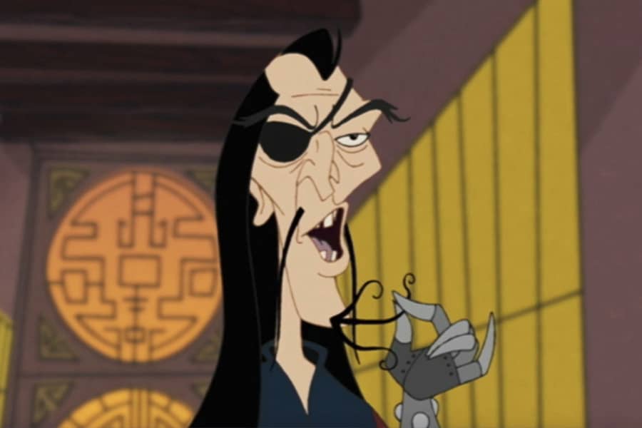 Khan, a wiry man with an eye patch and twirling a stringy beard