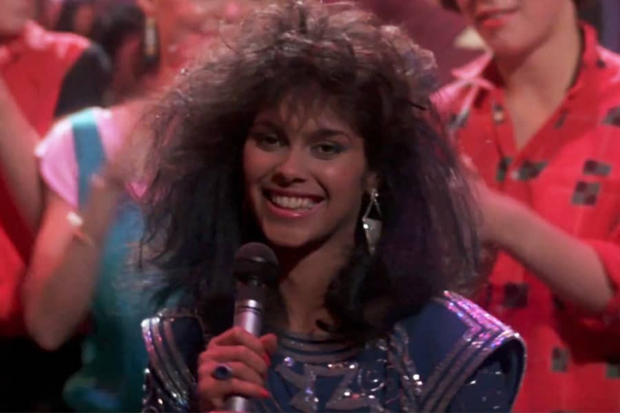 Laura Charles smiling with a microphone