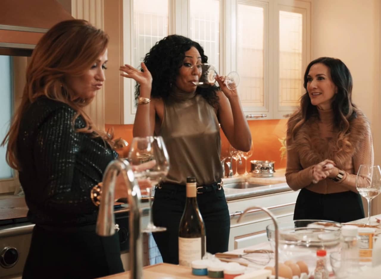Tracy, Maisie, and Wendy drinking wine in the kitchen