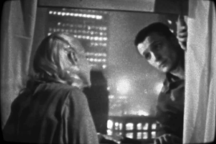 man looks into the window to speak to the woman