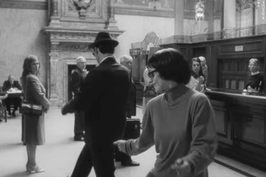 man and woman dancing in the bank teller line