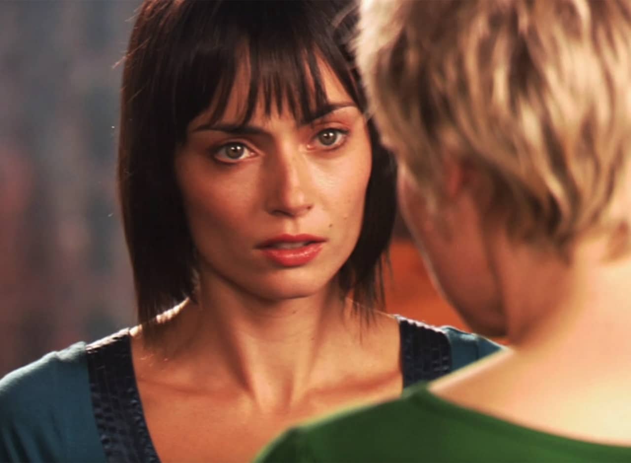 brunette woman speaking to a short-haired blonde woman