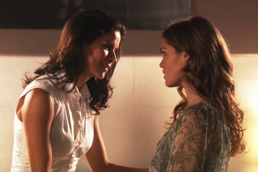 older brunette woman speaking with a younger woman