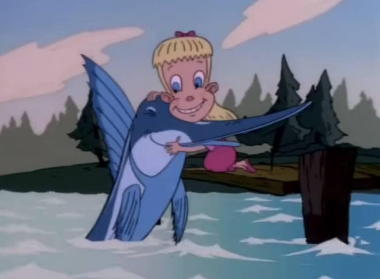 girl hugging marlin at the edge of a dock
