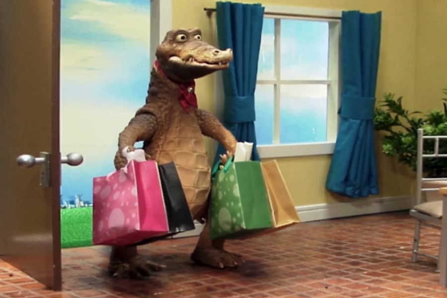Rico walking in the door carrying lots of shopping bags