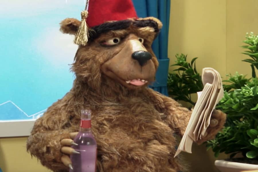 Morreski holding some paper and an alcohol bottle