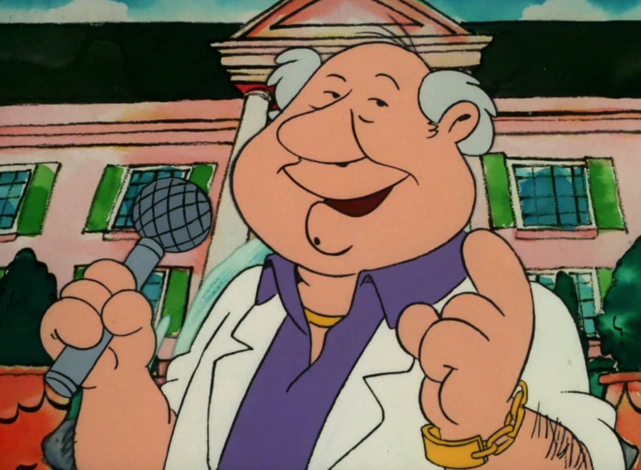 host of the show: a balding human man wearing a purple shirt and white blazer