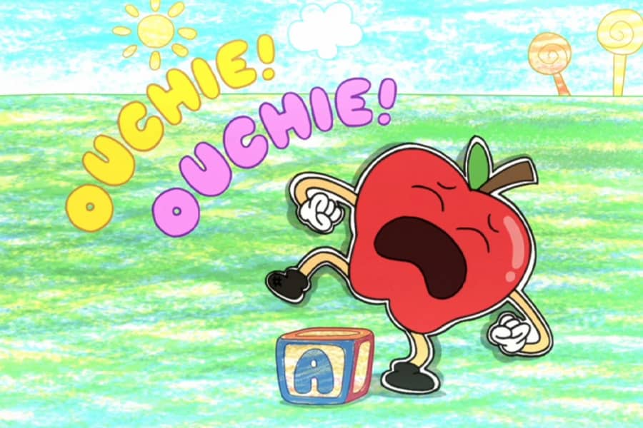 an apple bangs its toe on a block and says, “Ouchie!”