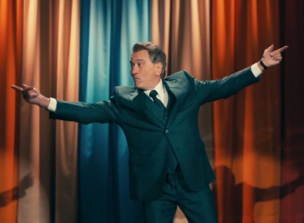 Murray Franklin dances in front of his colorful stage curtain