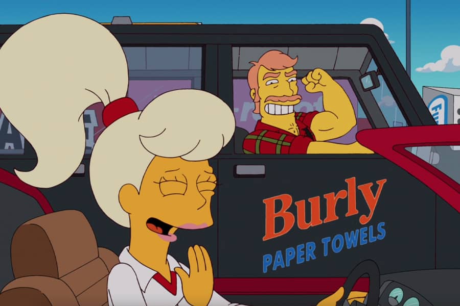 blonde Stacy in a car giggling as the Burly paper towel guy flexes in the car next to her