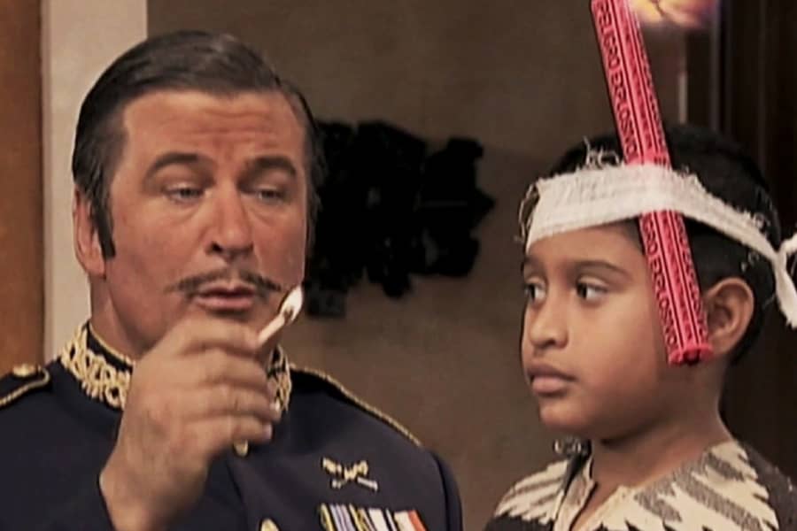El Generalissimo lights a stick of dynamite strapped to a child’s head