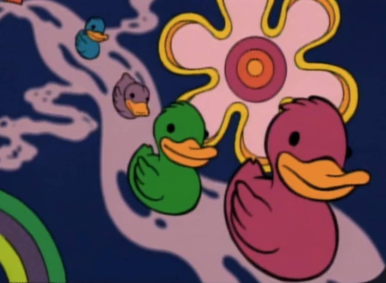 rainbow colored ducks floating along a purple haze