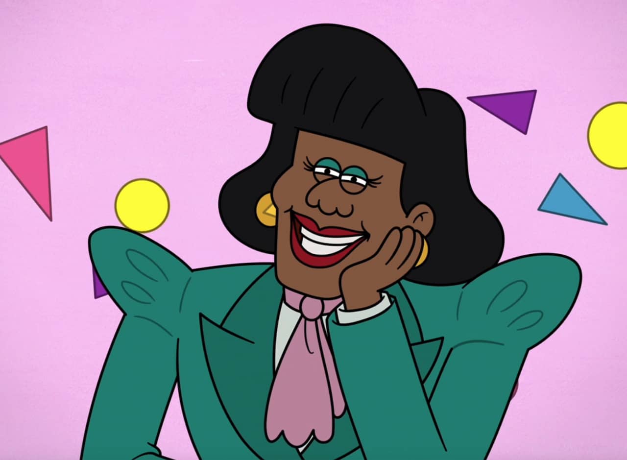 Joan Kranden, a black woman with ’90s hair and big shoulder pads