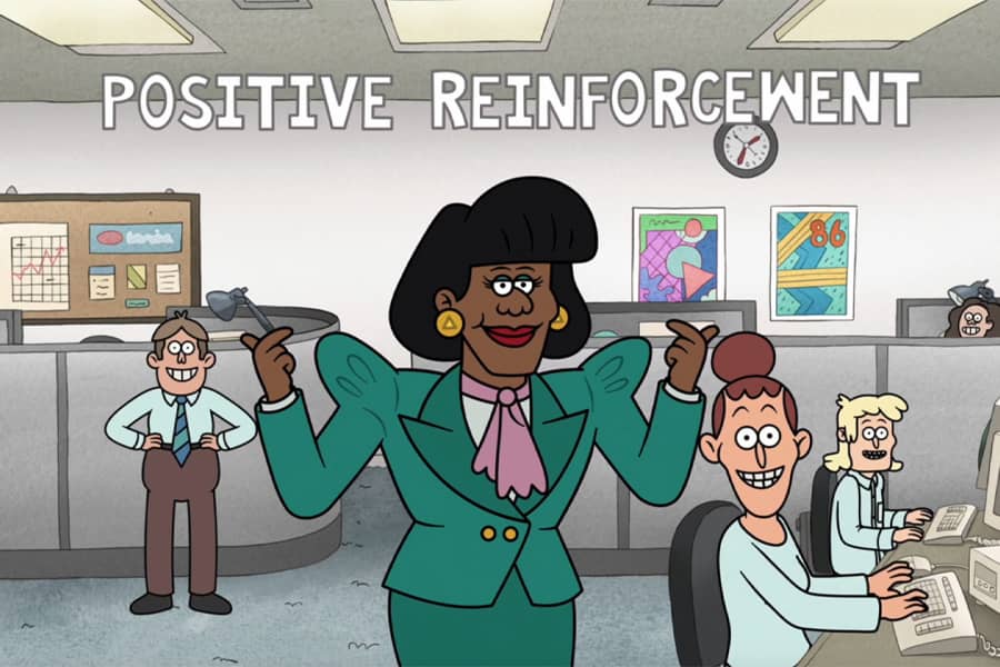 Joan in an office with the words “Positive reinforcement”