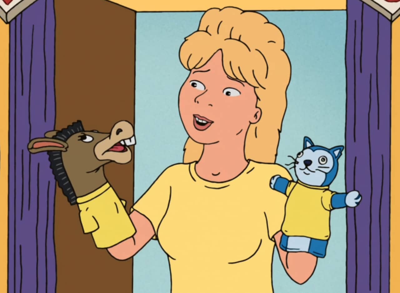Luanne Platter, a blonde woman, with donkey and cat puppets on her hands