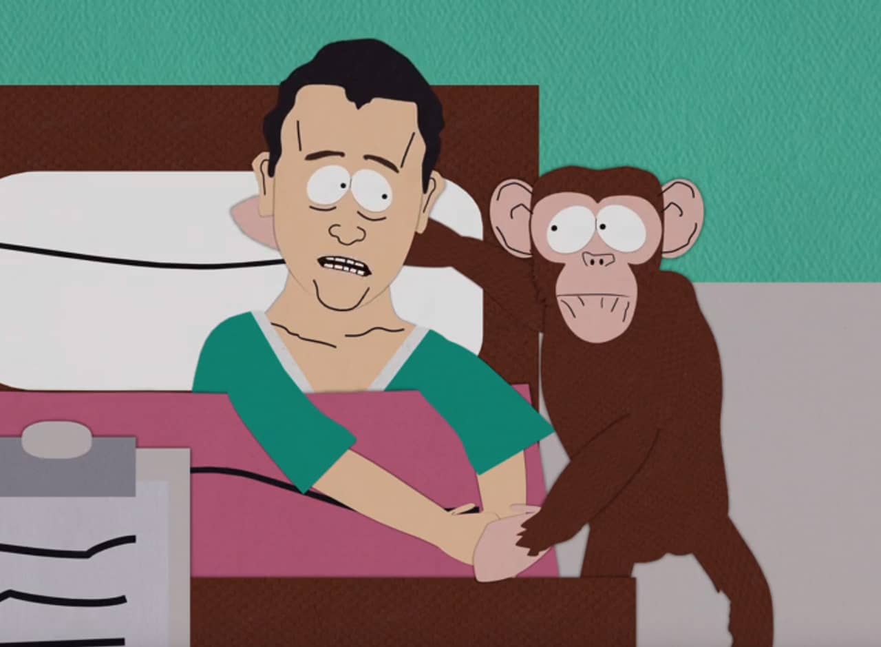 Tom Hanks, sick in a hospital bed, hugging a monkey