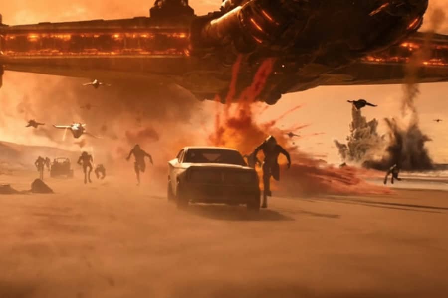 a car drives away from a huge spaceship with explosions and aliens