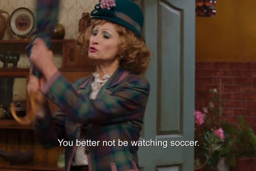 mother-in-law swinging an umbrella saying, “You better not be watching soccer”