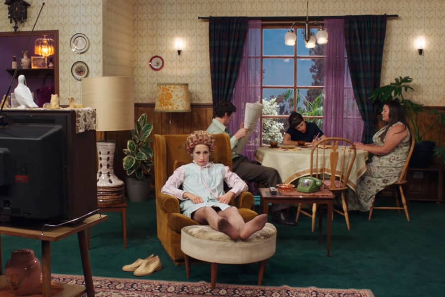 family room with mother-in-law in armchair with curlers in her hair