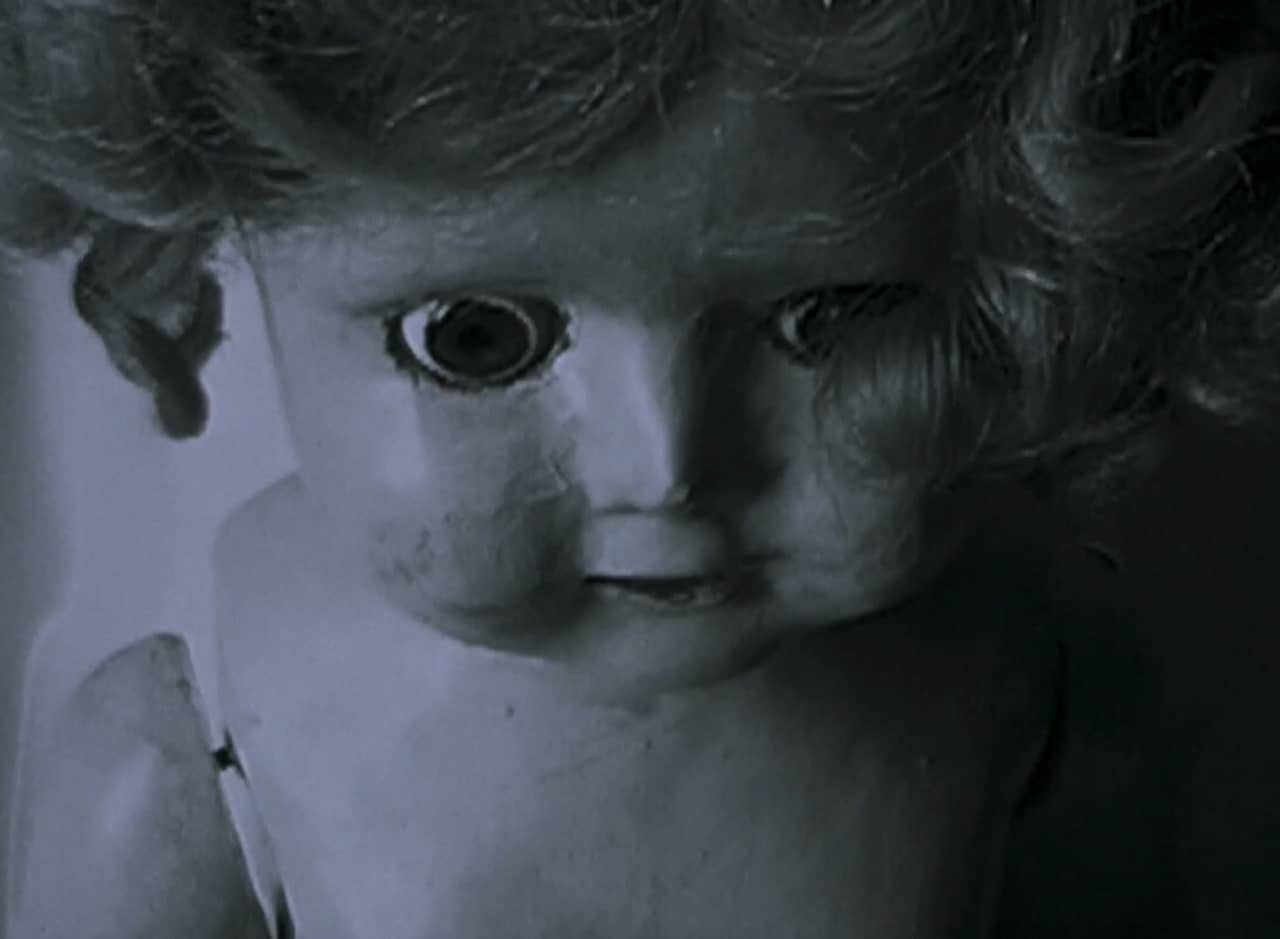 a black and white shot of a child’s doll