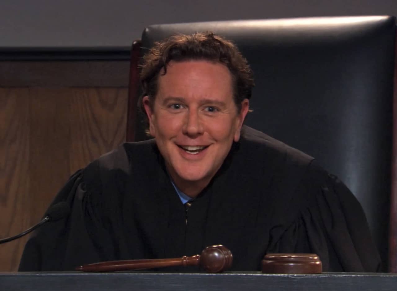 Judge Reinhold smiles from the bench