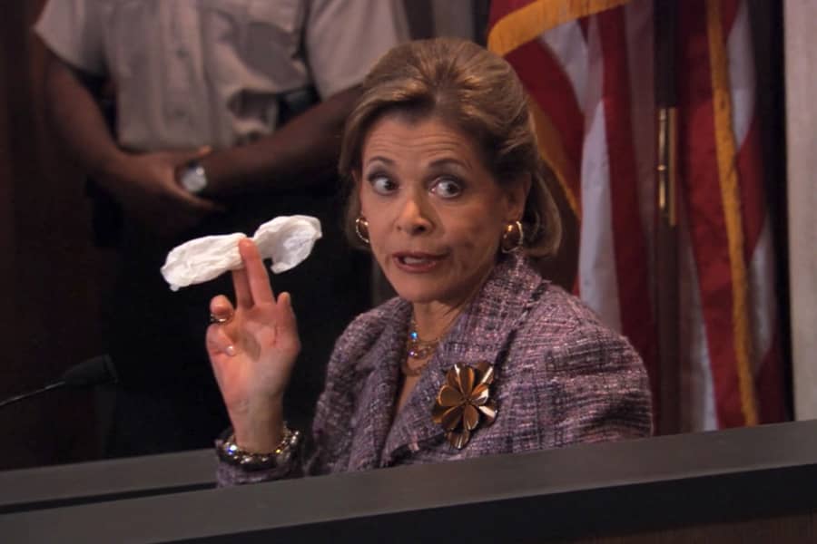 Lucille Bluth holds a tissue on the witness stand