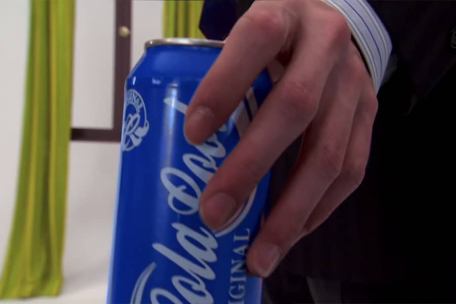 his hand grabs the soda