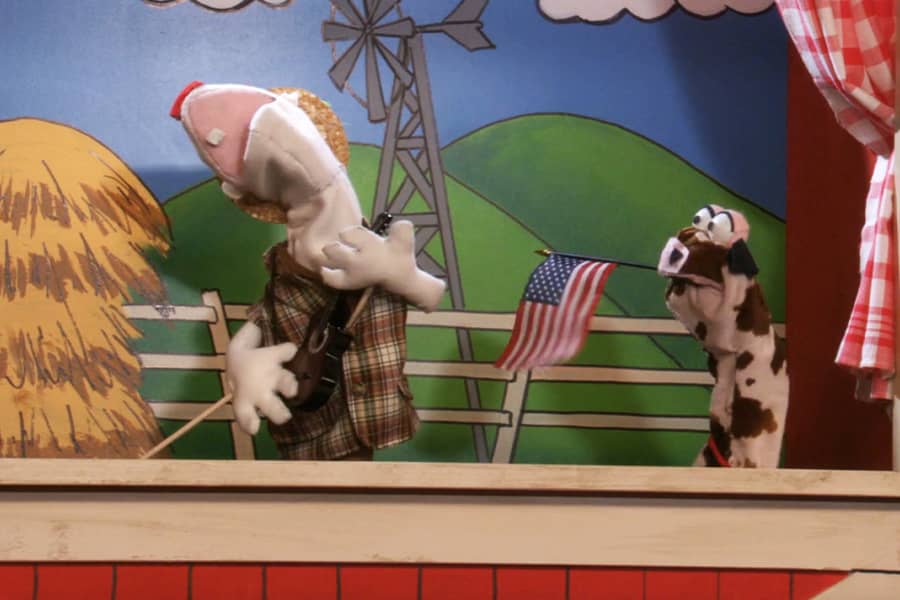 Monty singing and Moo-Moo waving an American flag