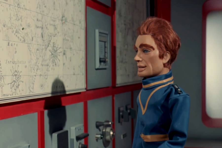 puppet captain looks at a map on the wall