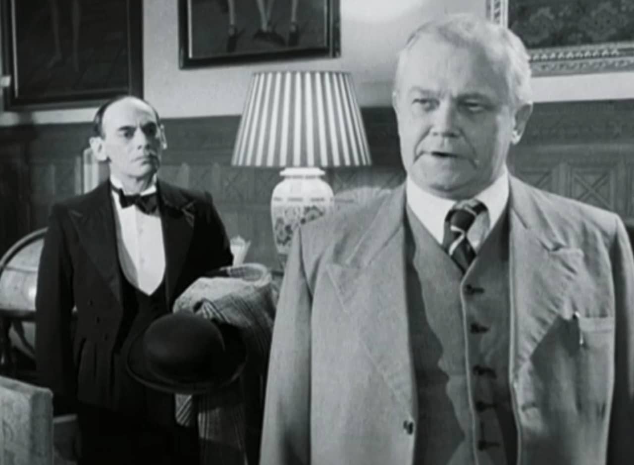 inspector speaks with the butler Barnsby behind him
