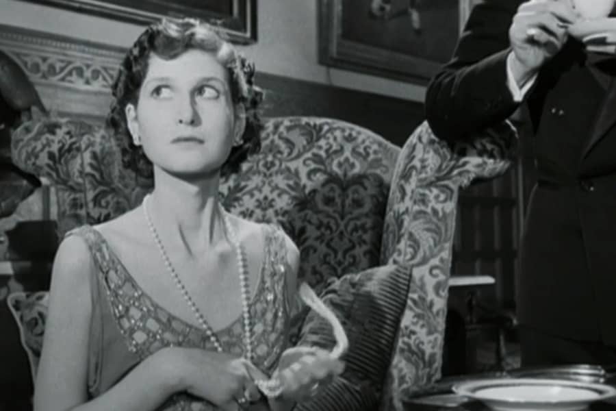 woman with pearls looks disinterested
