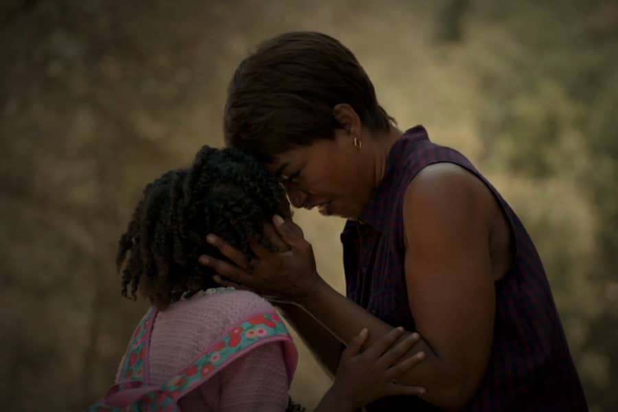 Monet Tumusiime as Lee Harris in an embrace with her daughter