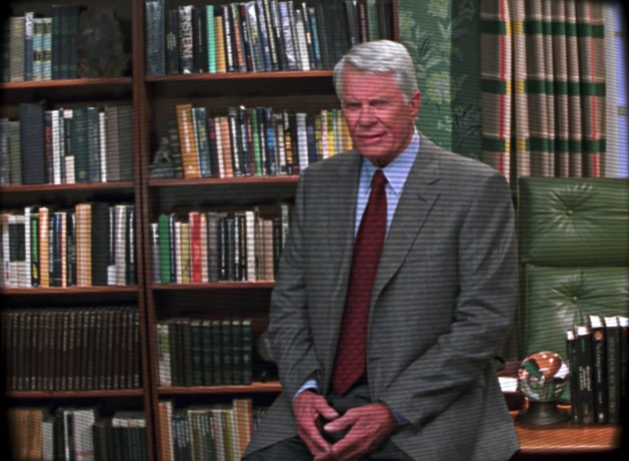 host Peter Graves sitting in a study