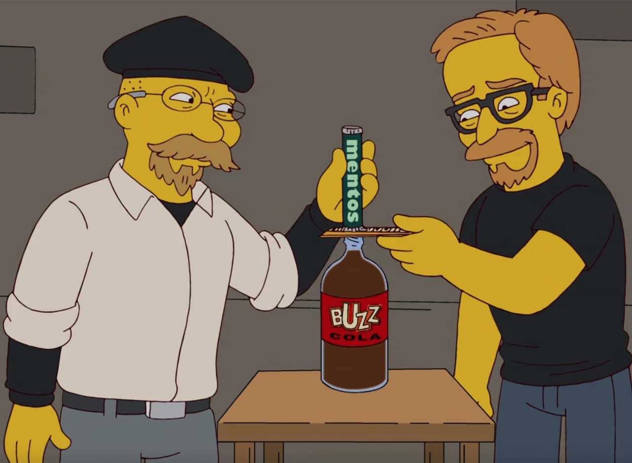 hosts about to pour Mentos in a soda bottle