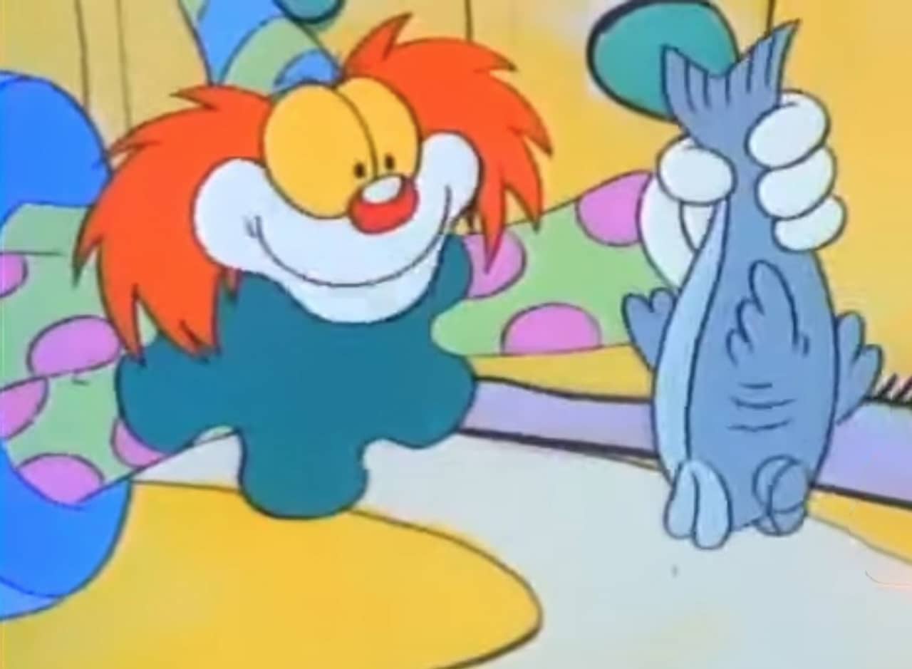 Binky the Clown holding a dead fish