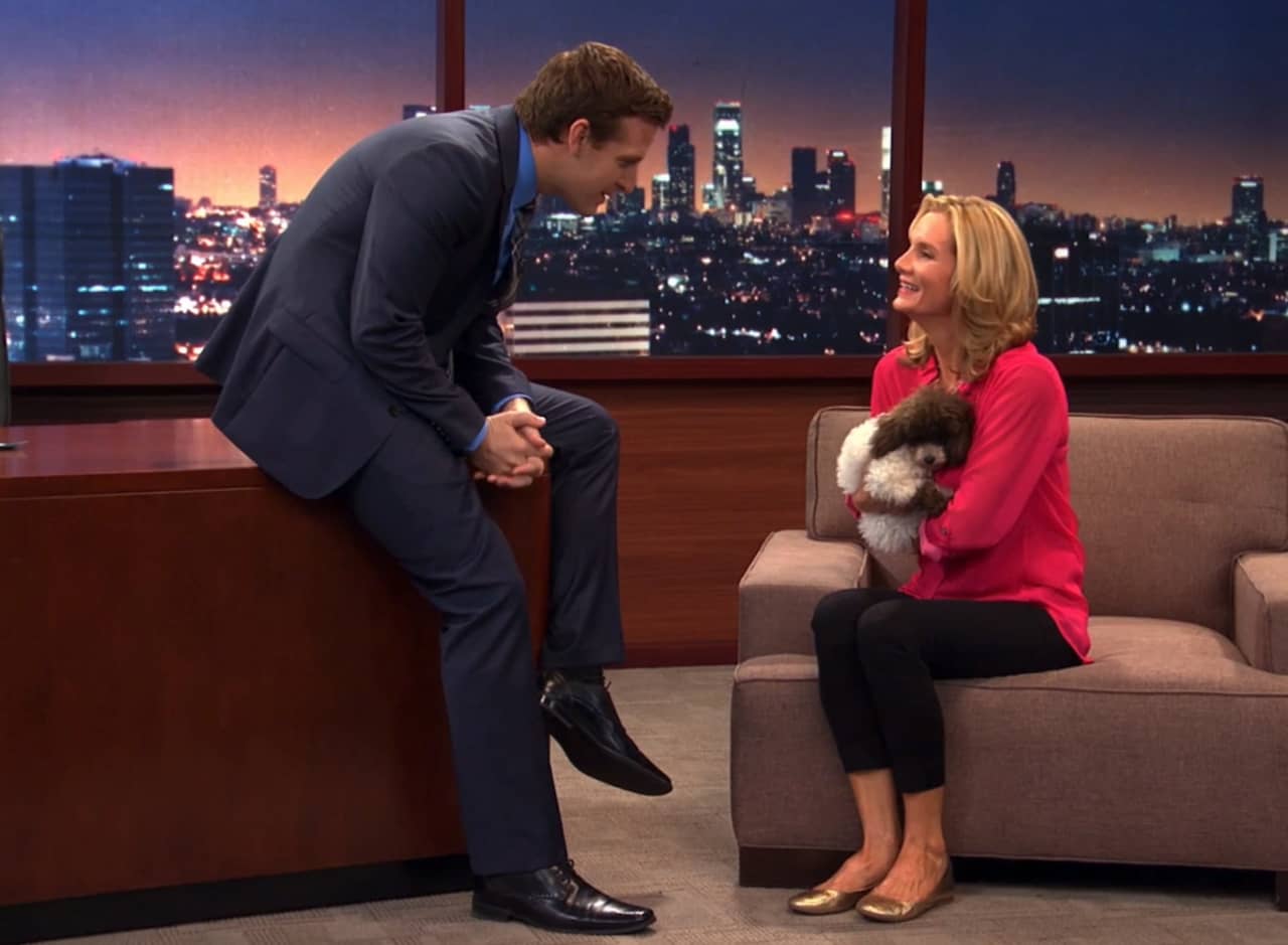 Graham Cavanaugh talking with a guest holding a puppy