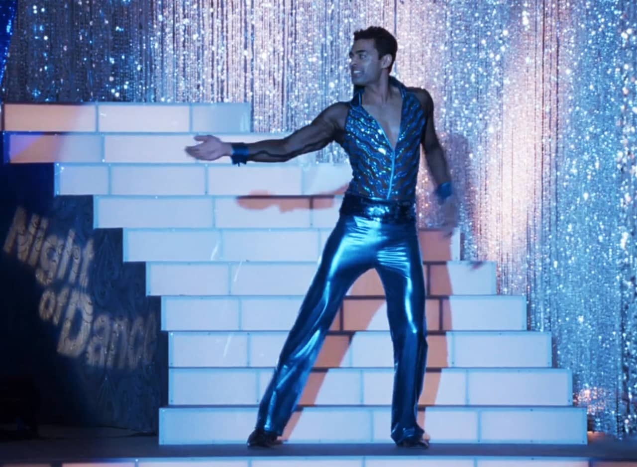 male contestant in a blue shimmery outfit