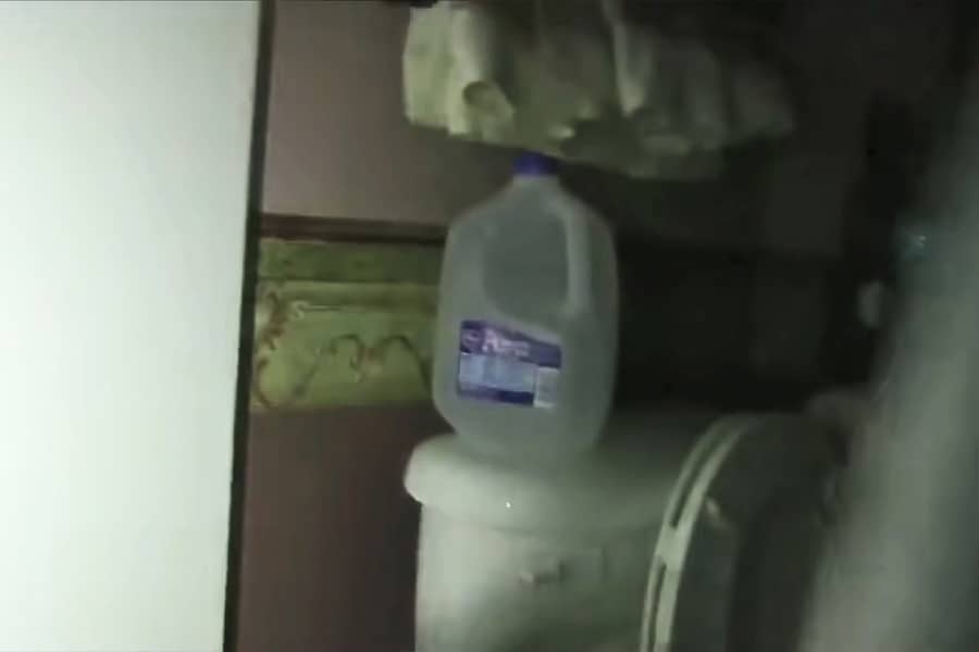 a peek out of the shower and the empty milk jug is sitting on the toilet tank