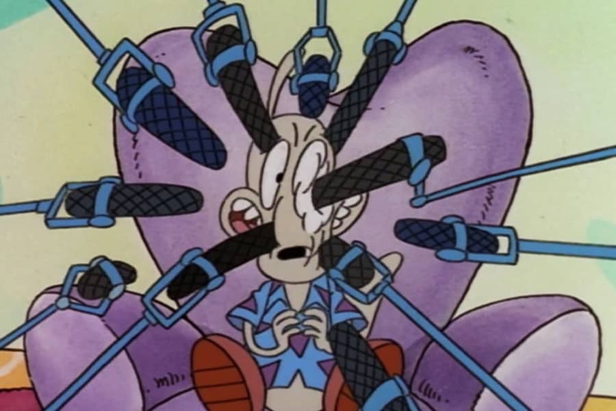 Rocko with a bunch of microphones circling his head, some poking his face and eyeballs