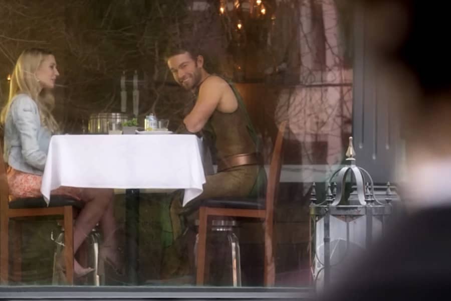 The Deep having dinner with a woman while a man watches them from a distance